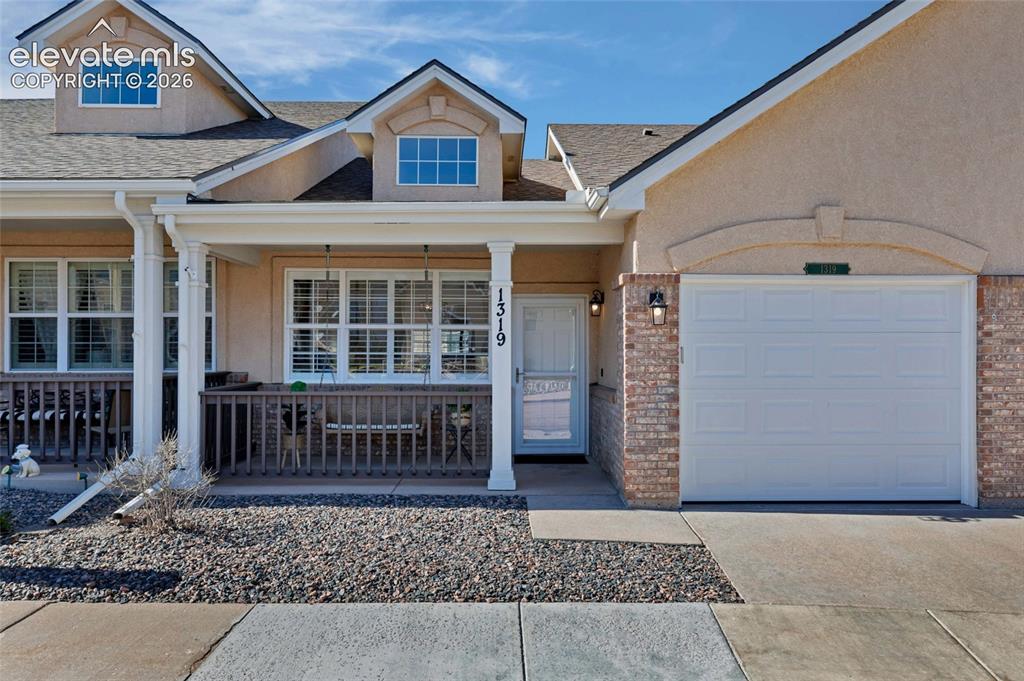 Image 1 of 26: A charming stucco and brick exterior welcomes you home, where a covered fro