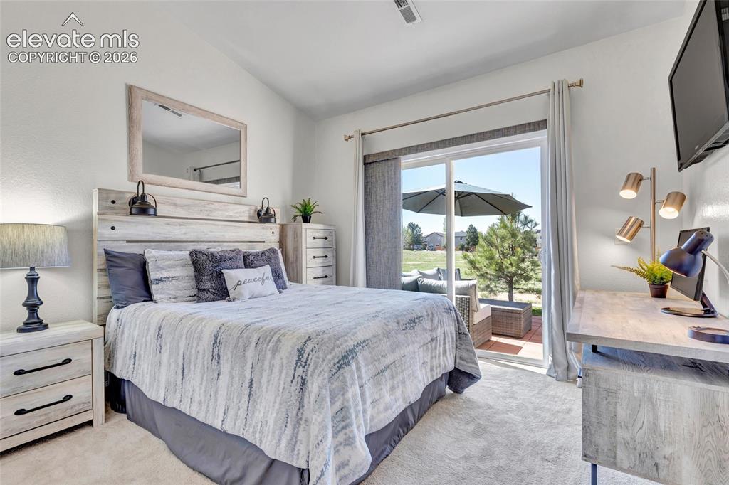 Image 19 of 26: The secondary bedroom is a serene retreat, with soft neutral tones and a sl