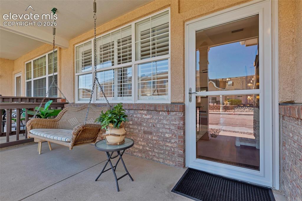 Image 3 of 26: The covered front porch is made for slow mornings, complete with a hanging