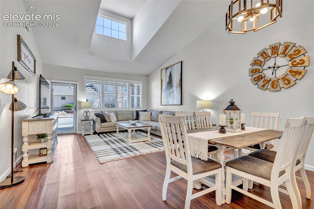 Image 5 of 26: The open-concept living and dining area is bathed in natural light, with va