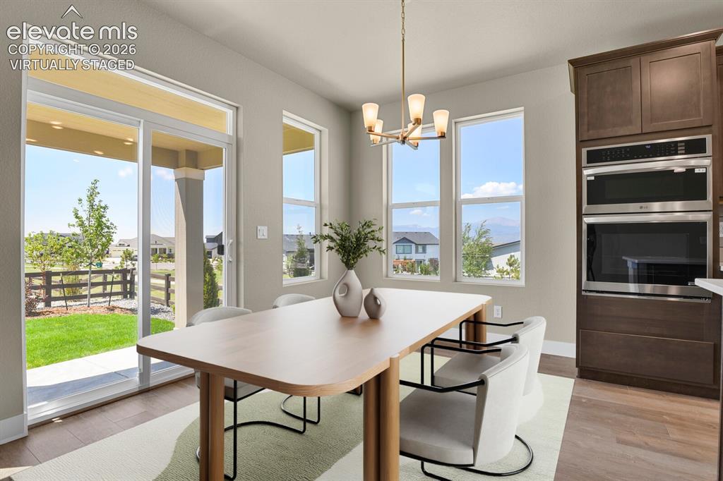 Image 12 of 42: Separate dining area with walk-out to backyard. Virtually Staged