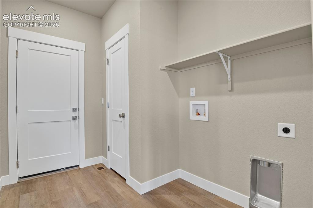Image 19 of 42: Convenient main level laundry with storage and access to the garage
