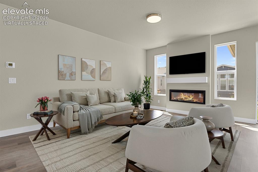 Image 8 of 42: Comfortable living space with electric fireplace. Virtually Staged