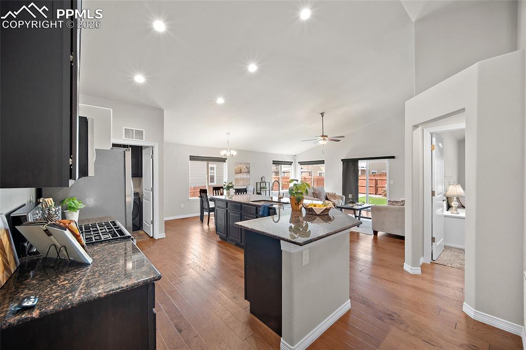 Image 4 of 50: Open concept with vaulted ceilings, hardwood flooring and tons of natural l