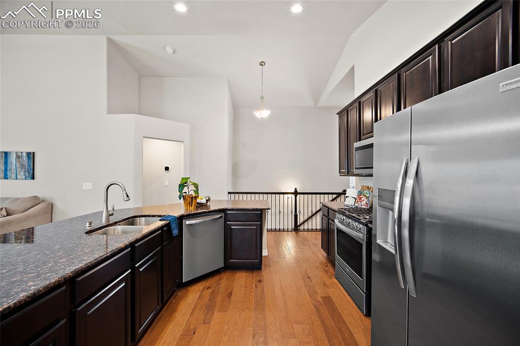 Image 6 of 50: Kitchen boasts SS, granite and dark cabinetry. 