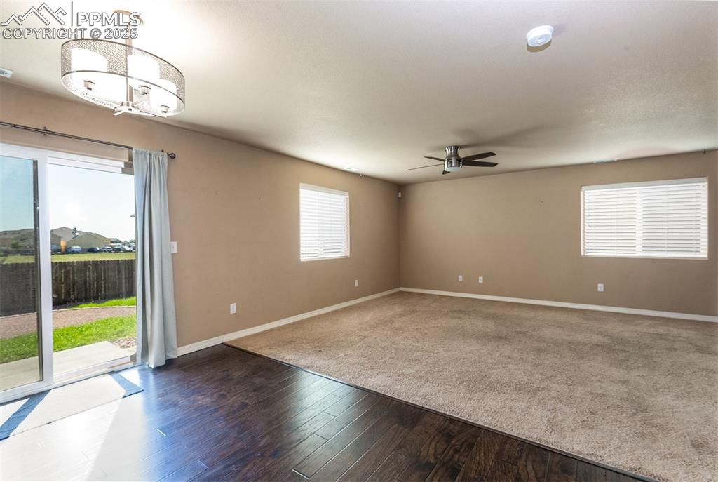 Image 15 of 33: Unfurnished room with healthy amount of natural light and dark wood finishe
