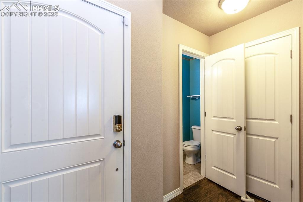 Image 17 of 33: Bathroom featuring dark wood finished floors and a textured ceiling