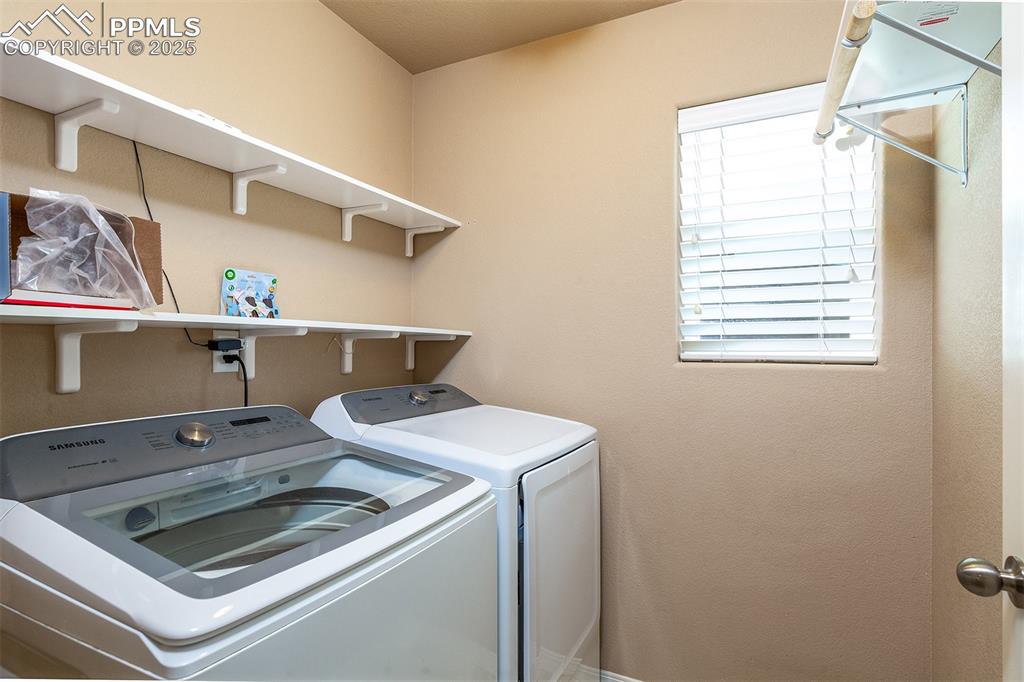 Image 19 of 33: Washroom featuring independent washer and dryer