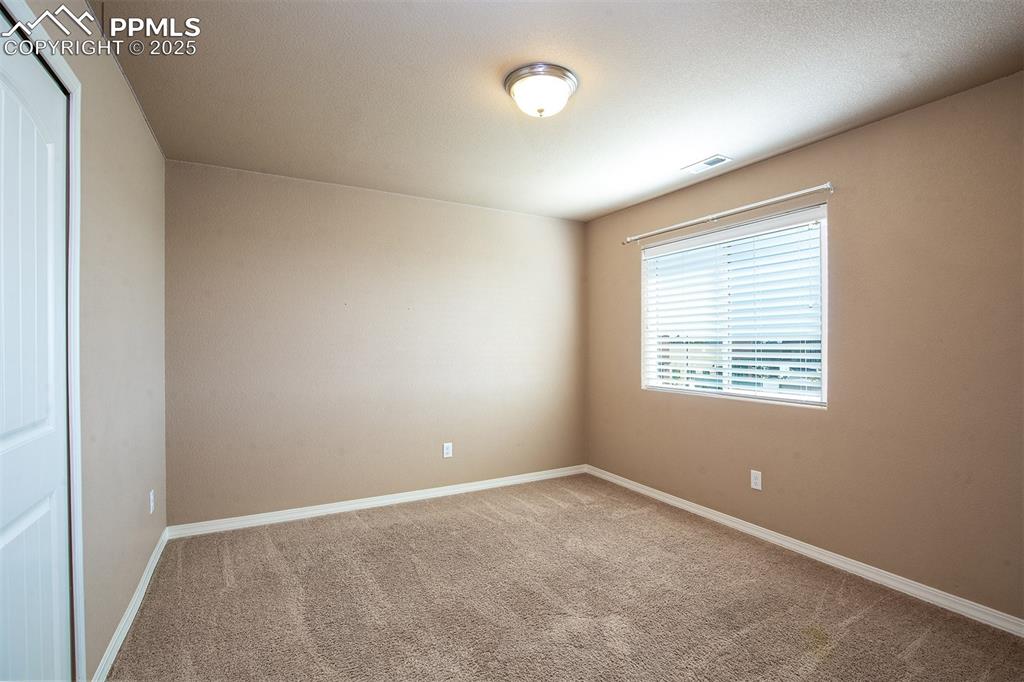 Image 22 of 33: Carpeted spare room featuring baseboards