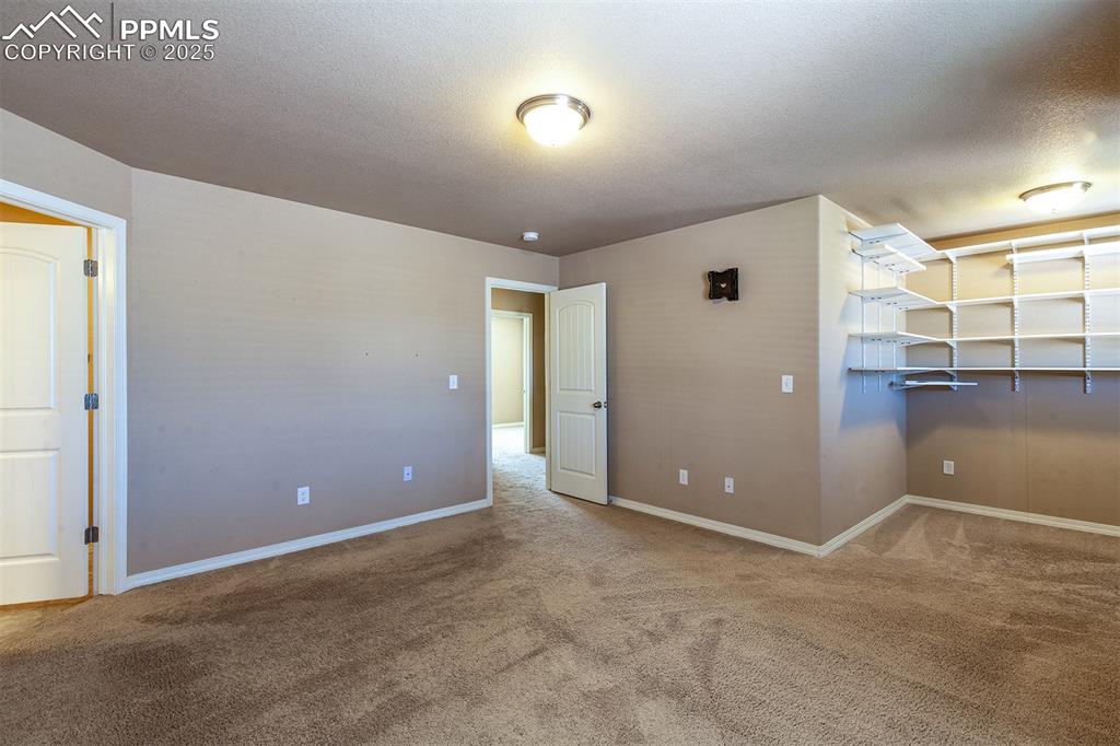 Image 26 of 33: Spare room with carpet floors and a textured ceiling