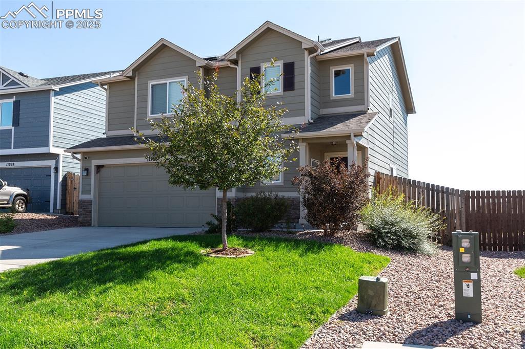 Image 3 of 33: View of front of house with driveway, an attached garage, and roof with shi