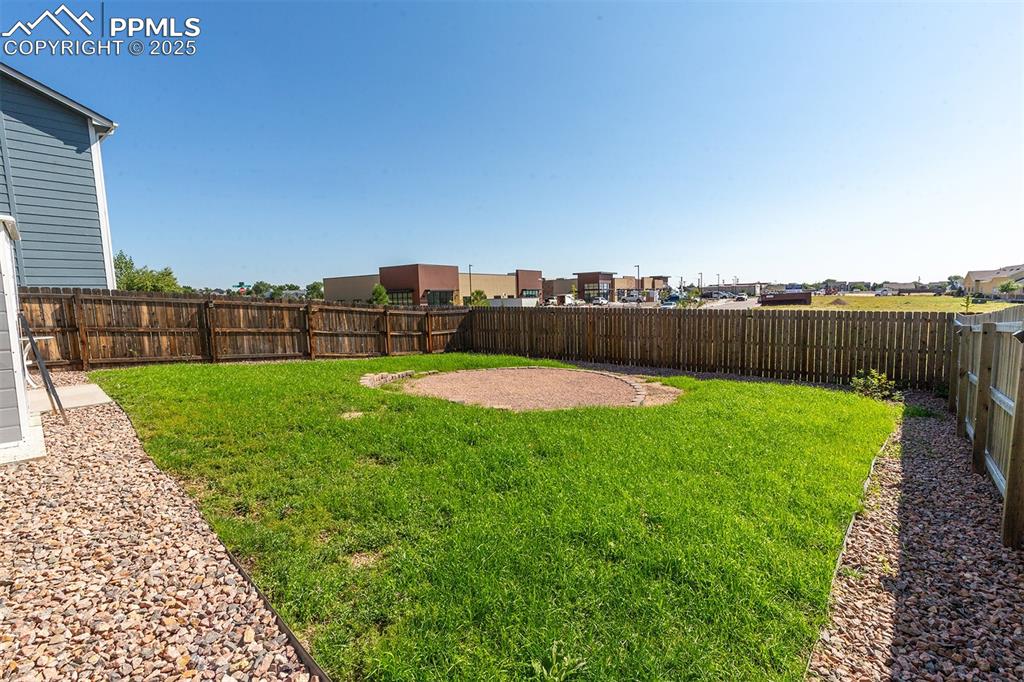 Image 33 of 33: Fenced backyard featuring a residential view