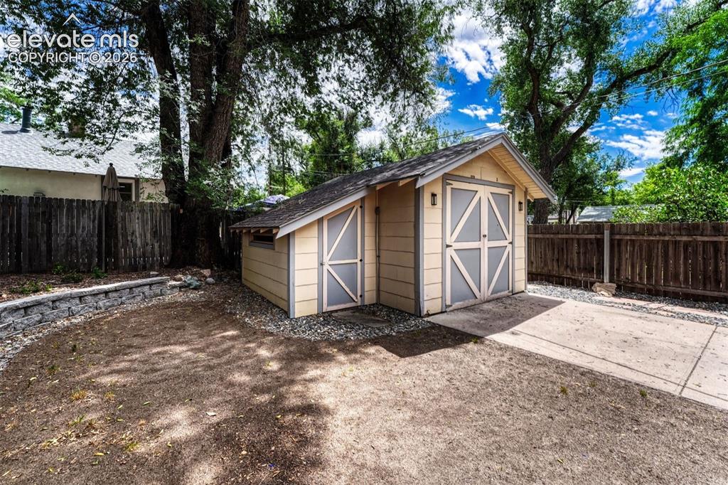Image 10 of 42: Storage shed and adjoining 1 car garage or workshop