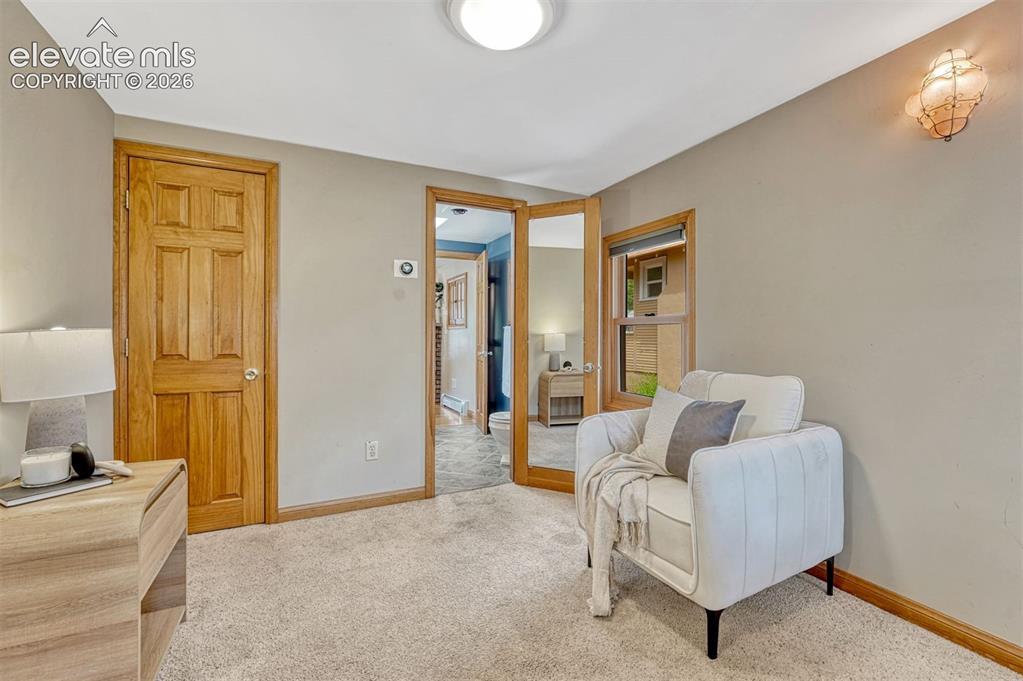 Image 22 of 42: Main bedroom features sitting area and adjoining bathroom