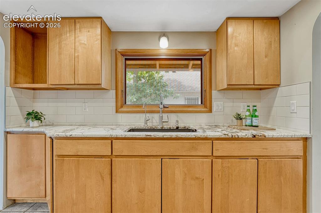 Image 24 of 42: Updated cabinets, sink, and lots of granite counter space