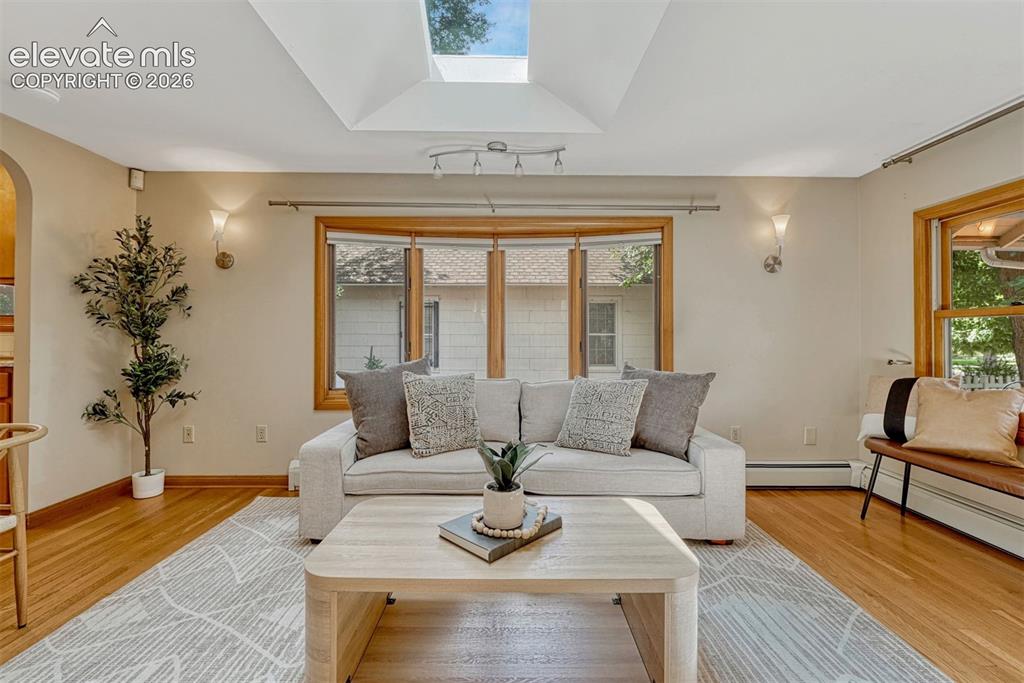 Image 3 of 42: Beautiful oak flooring and skylight emits lots of natural light