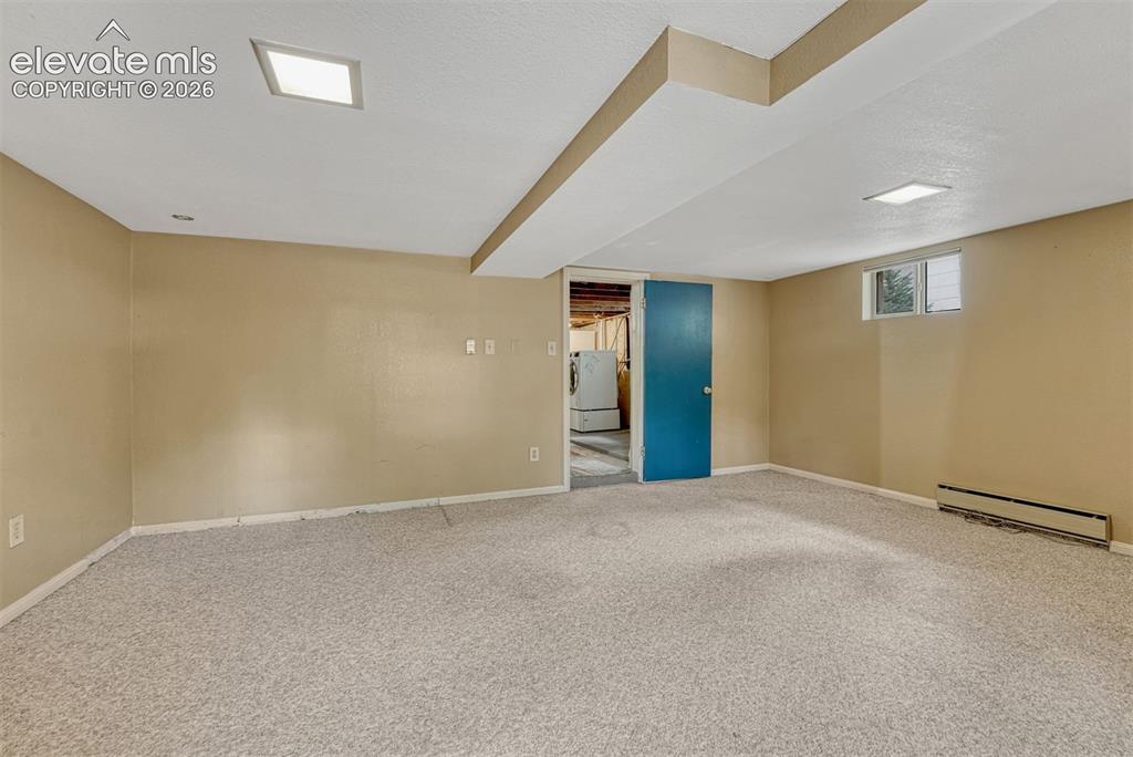 Image 31 of 42: Just add a wardrobe to this very large basement bedroom