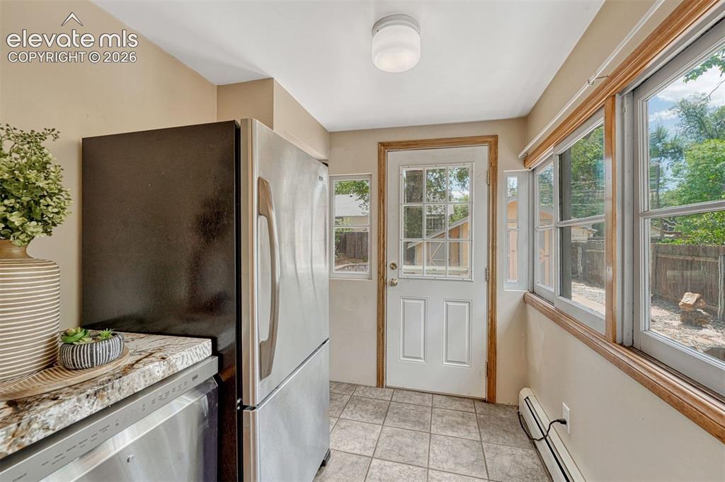 Image 6 of 42: Stainless steel appliances including dishwasher and refrigerator