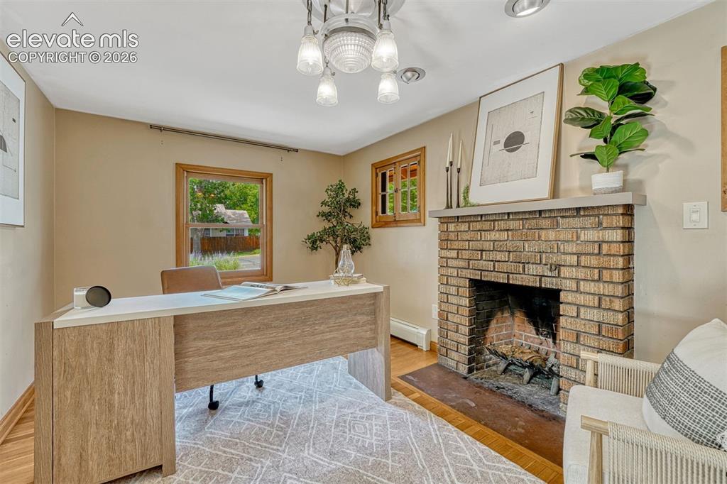 Image 8 of 42: The stone fireplace is the feature of this room that can be used as a bedro