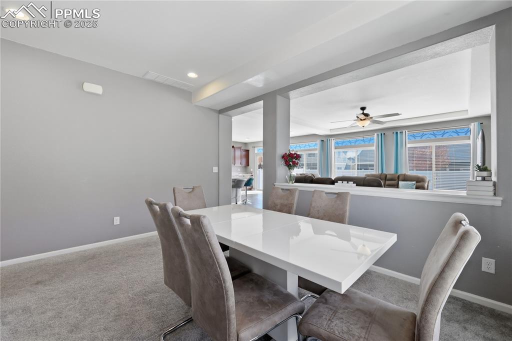Image 10 of 37: Carpeted dining space with ceiling fan and recessed lighting