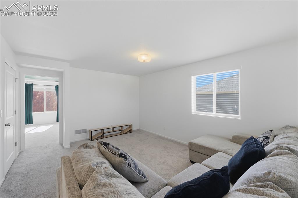 Image 18 of 37: Carpeted living area featuring baseboards