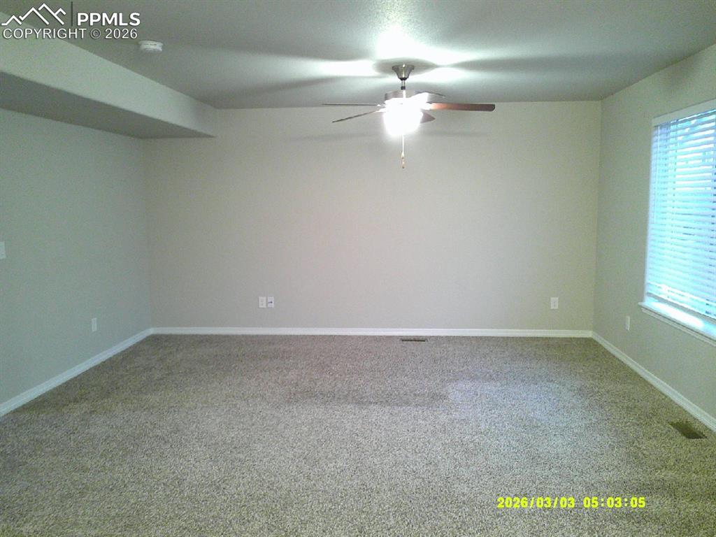 Image 2 of 16: Carpeted spare room with ceiling fan and baseboards
