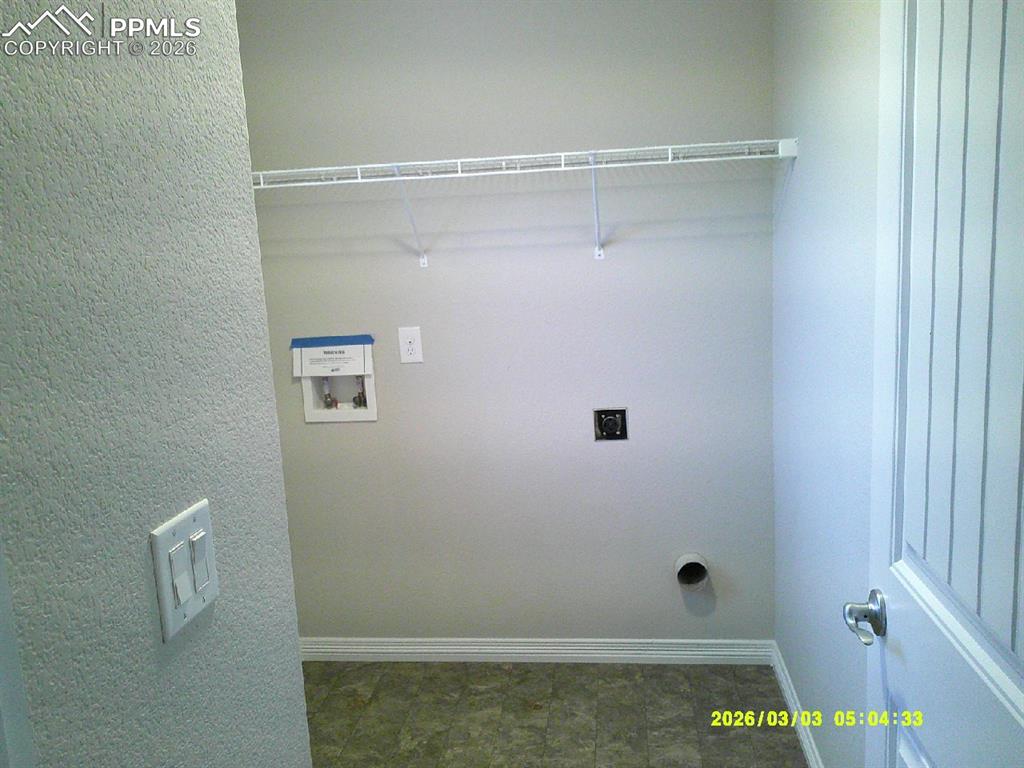 Image 5 of 16: Laundry area with washer hookup, hookup for an electric dryer, and a textur