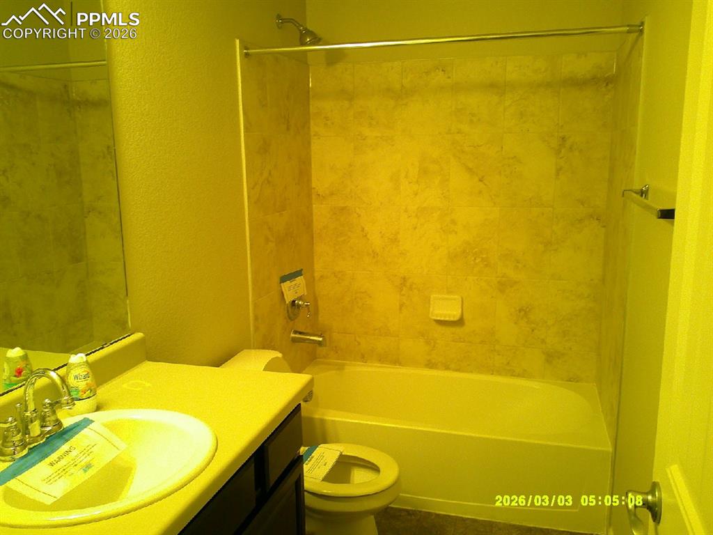 Image 7 of 16: Bathroom featuring vanity, a textured wall, and shower / washtub combinatio
