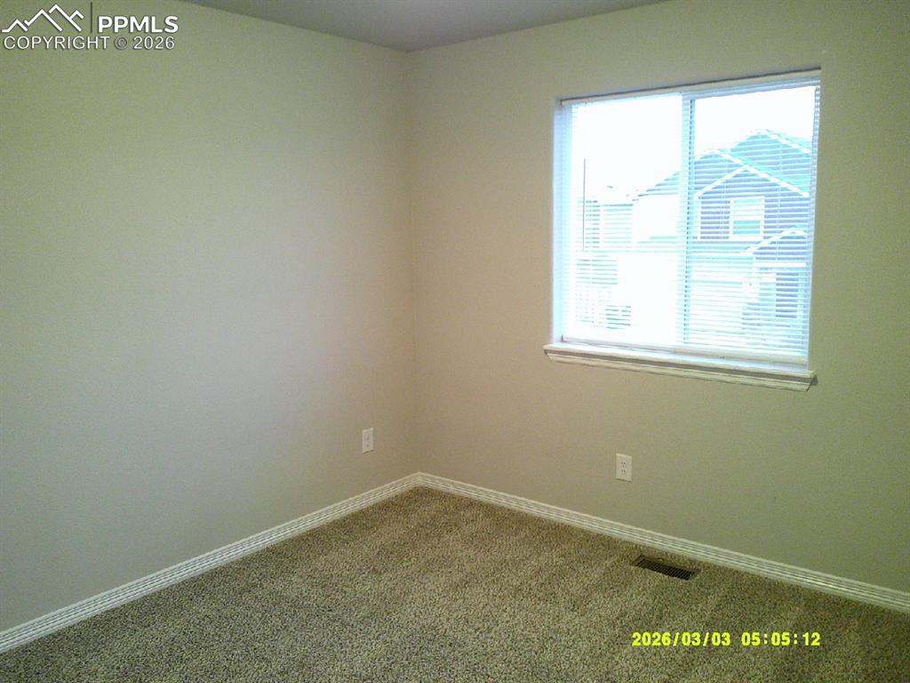 Image 8 of 16: Carpeted spare room featuring baseboards