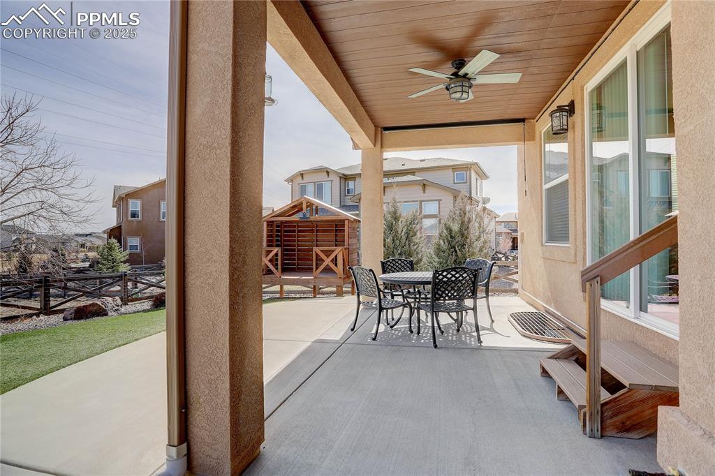 Image 13 of 43: View of patio featuring outdoor dining area, a ceiling fan, and fence