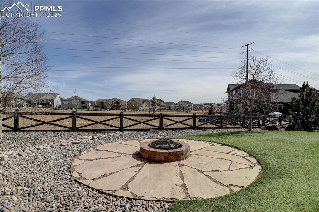 Image 9 of 43: View of yard with a patio area, fence, a residential view, and an outdoor f