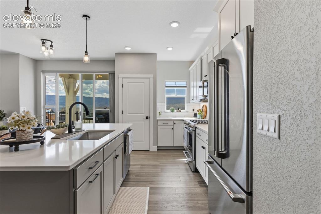 Image 11 of 46: Kitchen looking back towards the front door and living/dining combo