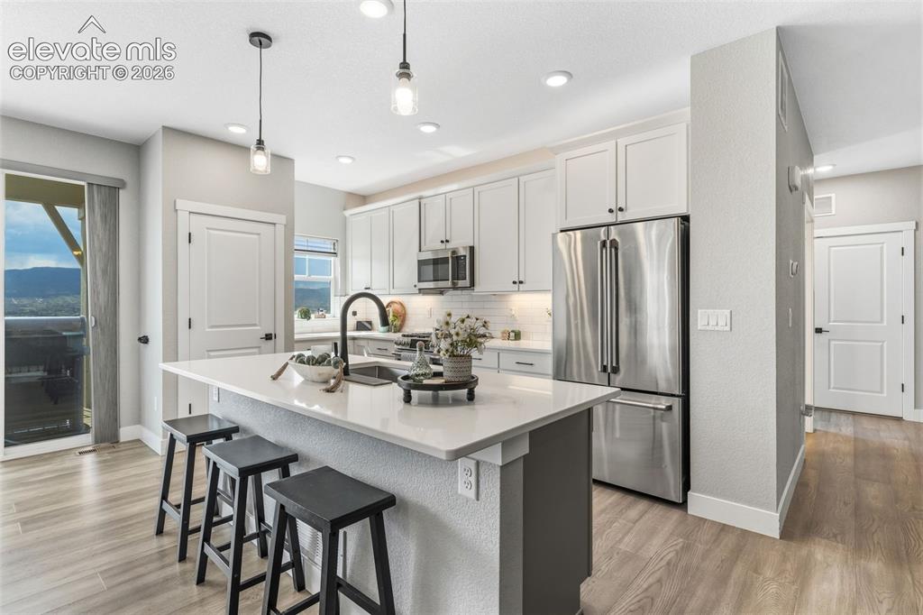 Image 13 of 46: Kitchen w/ pantry and deck walk-out