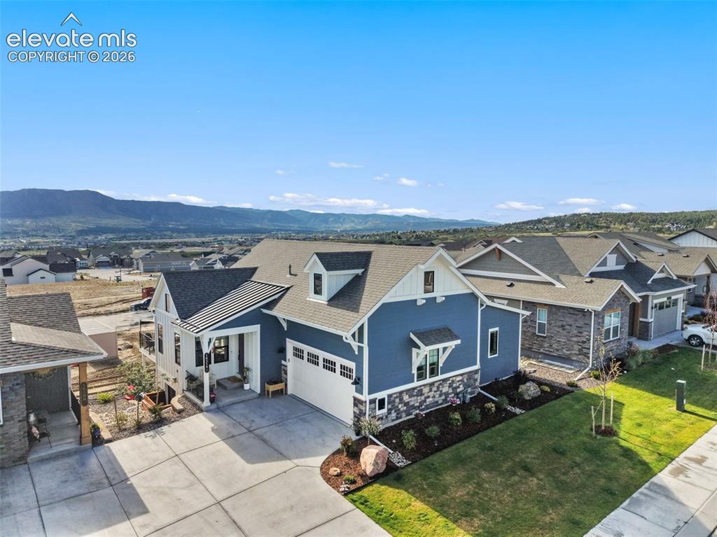 Image 42 of 46: Back view of the house w/ luxury turf on the ground level