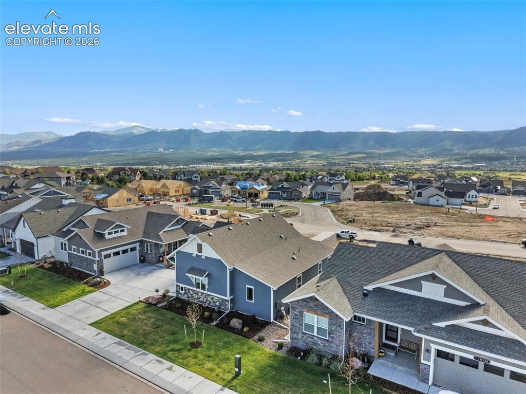 Image 6 of 46: Covered Front Porch and community maintained landscaping