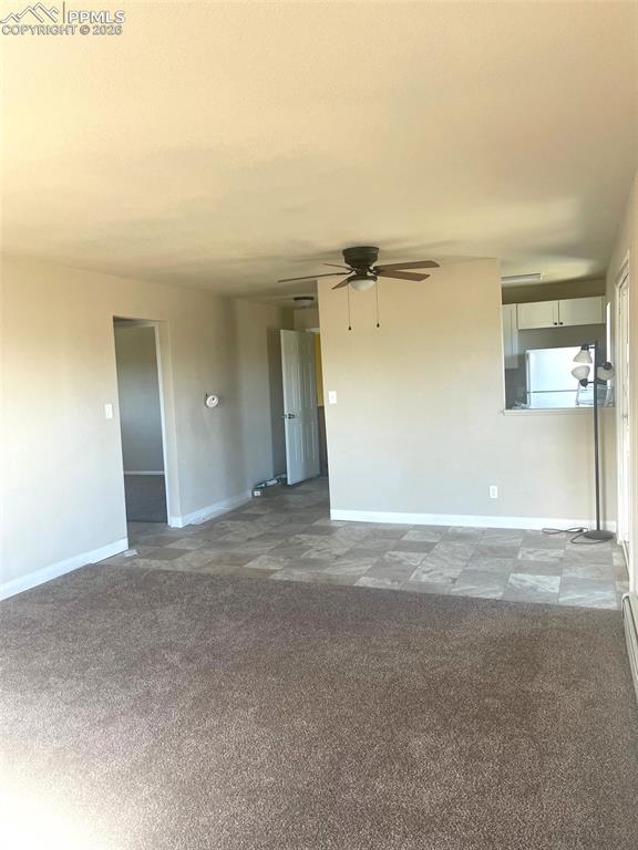 Image 3 of 28: view from living room to dining area, kitchen and front door