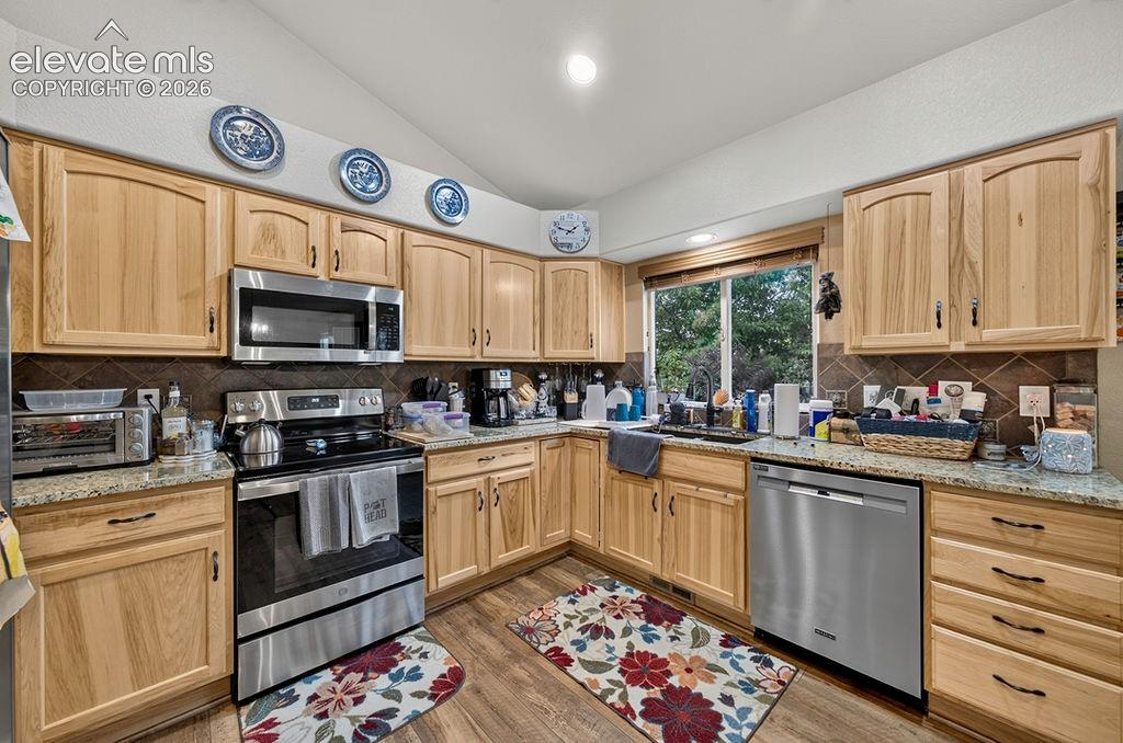 Image 11 of 44: Stainless steel appliances incl a dishwasher, smooth-top range oven, built-