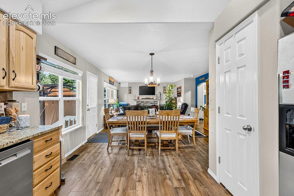 Image 12 of 44: View of the Dining Area and Family Room from the Kitchen.