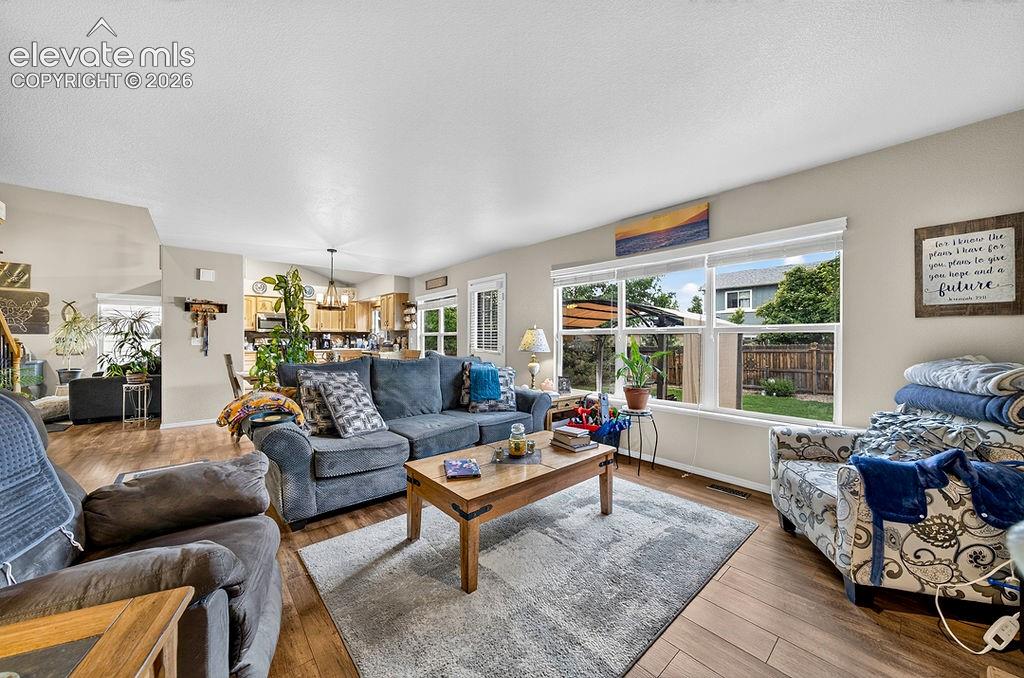 Image 14 of 44: Luxury vinyl plank flooring continues through the Family Room, Dining Area,