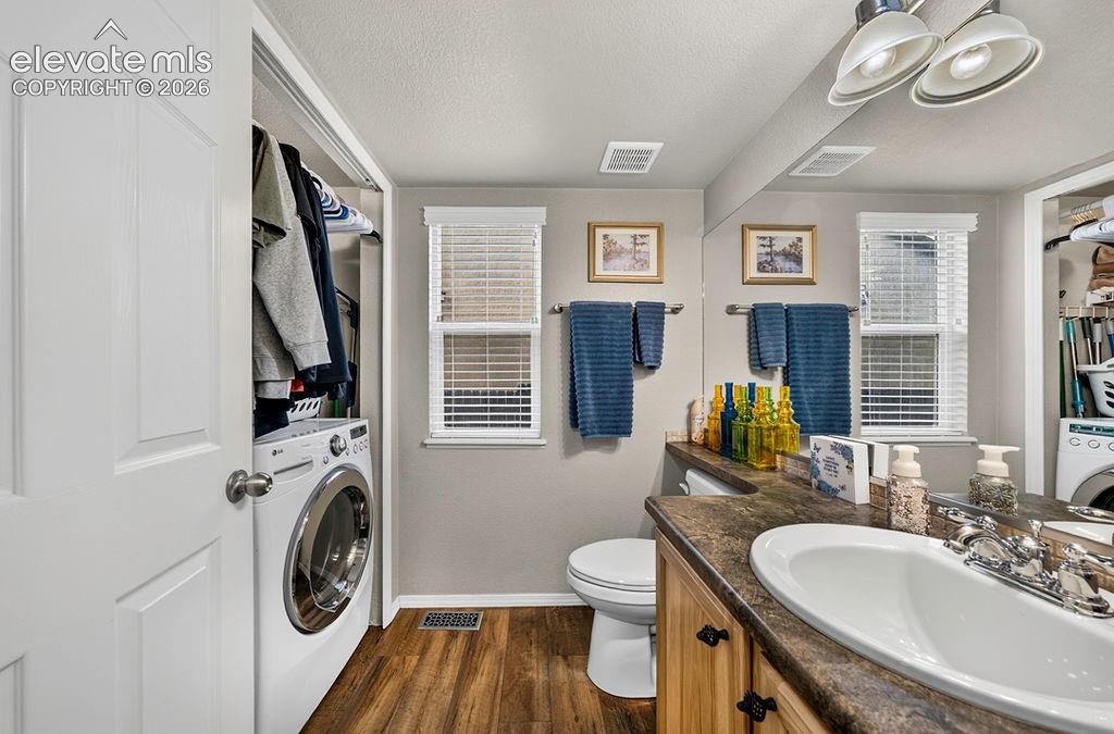 Image 19 of 44: Main level Powder Bathroom and Laundry Area.