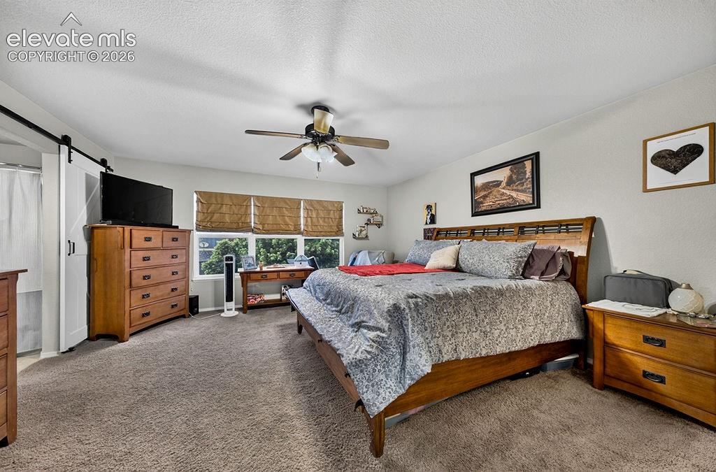 Image 21 of 44: The large upper level Primary Bedroom is a private retreat with neutral car
