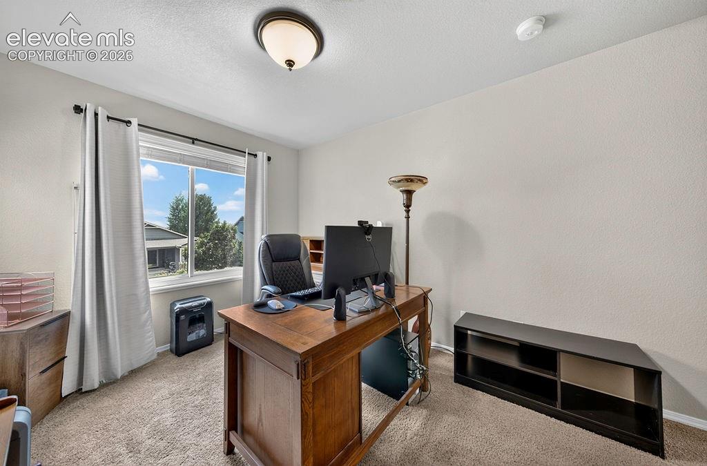 Image 29 of 44: Upper Level Bedroom #3 has neutral carpet (currently used as a home office)