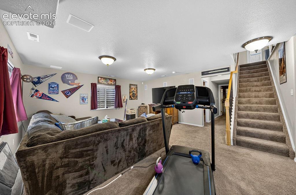 Image 36 of 44: Stairs to the main level from the Basement Family Room.