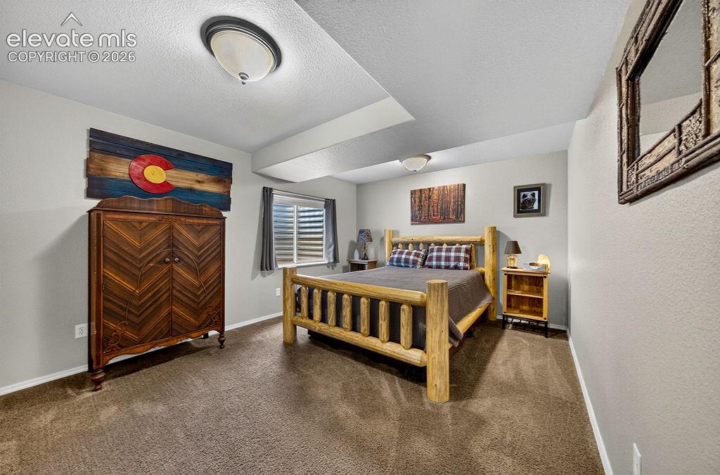 Image 37 of 44: Basement Bedroom #4 has neutral carpet.