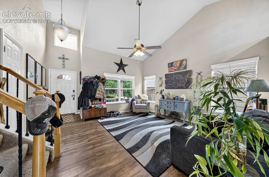 Image 4 of 44: Front Entry into the spacious Living Room that has a lighted ceiling fan an