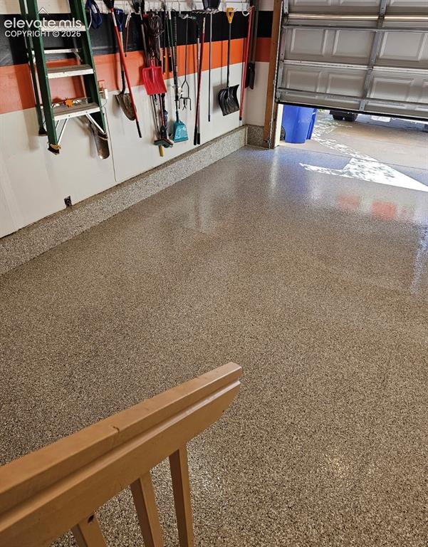 Image 43 of 44: Beautifully finished epoxy floor in garage.