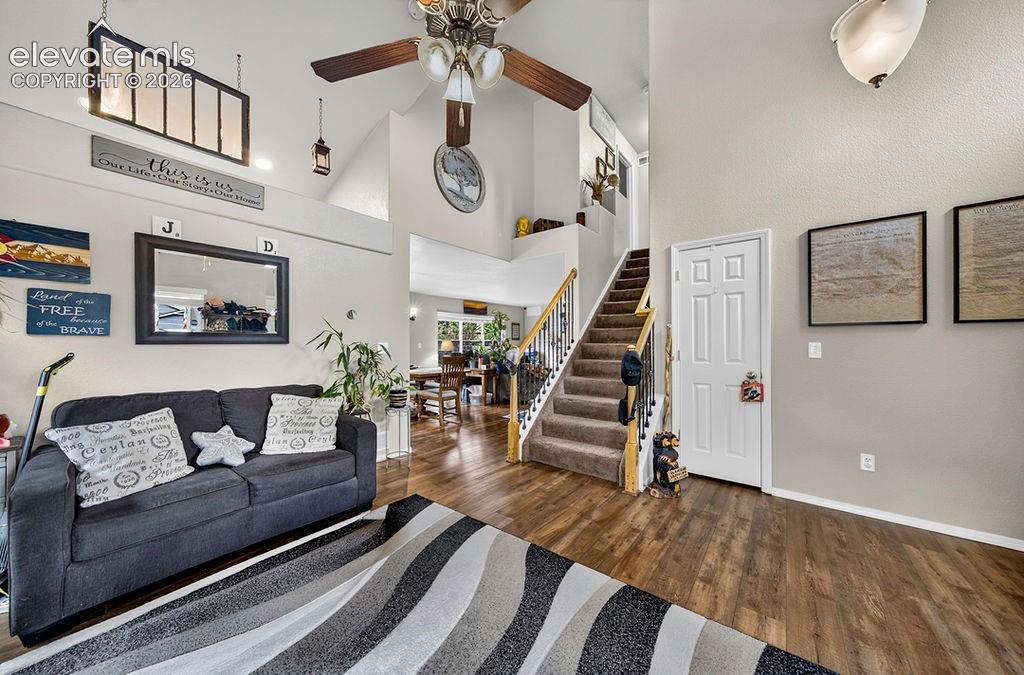 Image 5 of 44: View from the Living Room into the Dining Area and Family Room with iron st