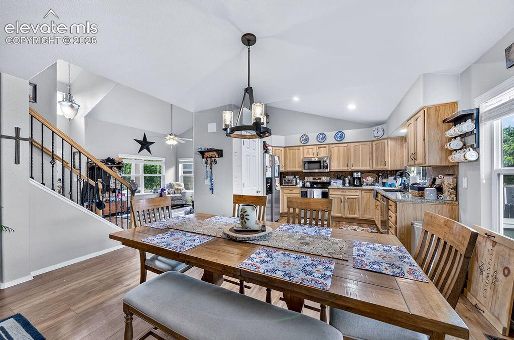 Image 6 of 44: View of the Living Room and Kitchen from the Dining Area.