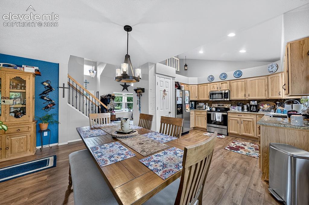 Image 7 of 44: The Dining Area has a modern light fixture and is conveniently located off