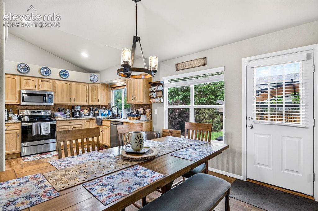 Image 8 of 44: Walk out from the Dining Area and Kitchen to a concrete patio with a covere